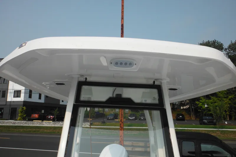 Slide: The Image of 2026 Tidewater 232 LXF boat T-top and console, parked outdoors. - 35