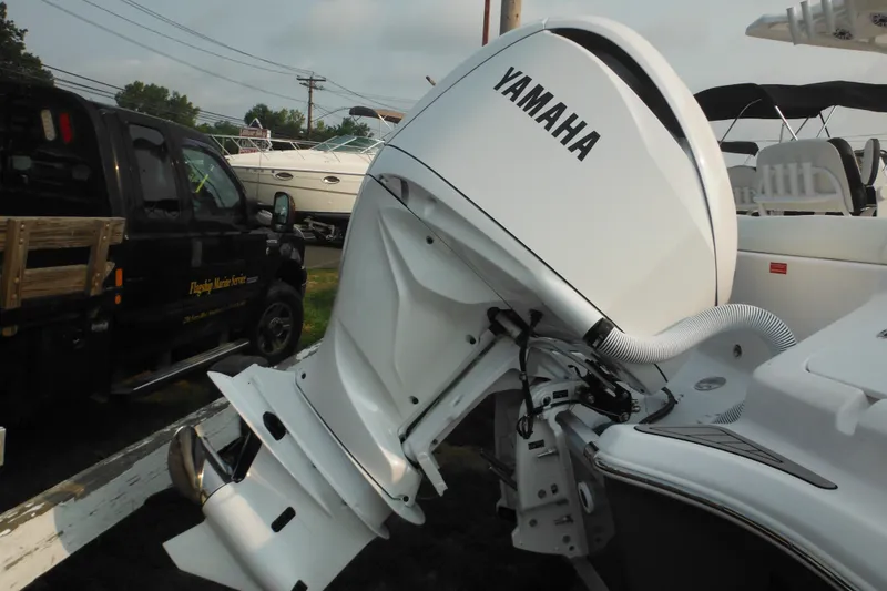 Slide: The Image of 2026 Tidewater 232 LXF boat with Yamaha outboard motor, parked near a service truck. - 4