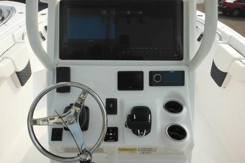 Slide: The Image of 2026 Tidewater 232 LXF boat console with steering wheel, controls, and display screens. - 42