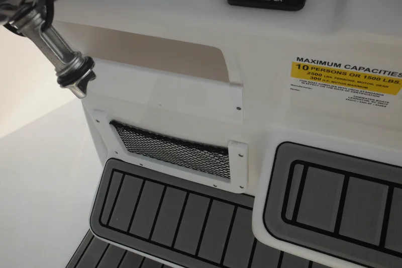 Slide: The Image of 2026 Tidewater 232 LXF boat deck with capacity label and storage net. - 44