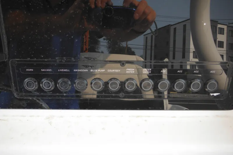 Slide: The Image of Control panel of a 2026 Tidewater 232 LXF boat with various switches. - 46