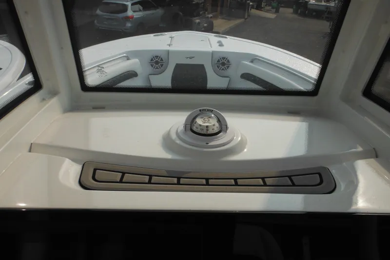 Slide: The Image of Interior view of 2026 Tidewater 232 LXF boat dashboard with compass and controls. - 53