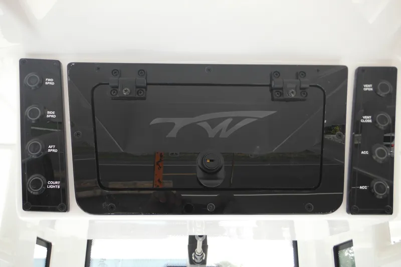 Slide: The Image of 2026 Tidewater 232 LXF boat control panel with switches and logo. - 54