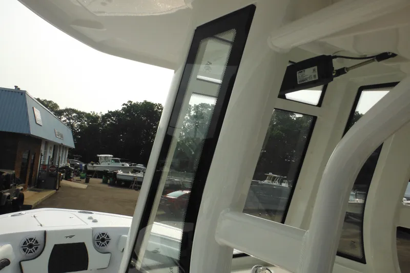 Slide: The Image of 2026 Tidewater 232 LXF boat interior with view of marina and dealership. - 59