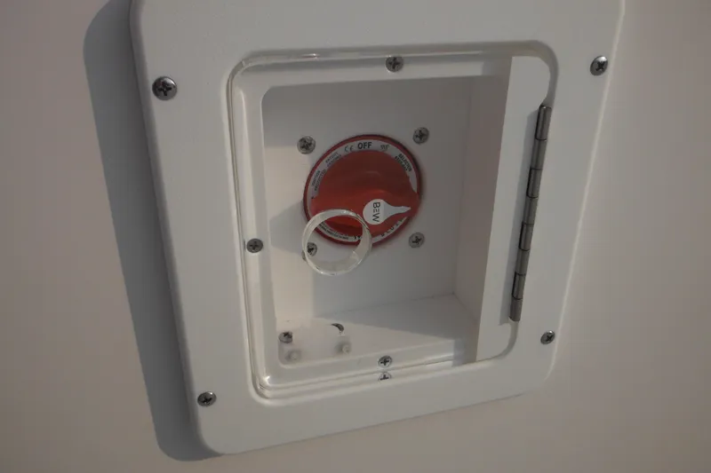 Slide: The Image of 2026 Tidewater 232 LXF boat battery switch compartment with red dial. - 62