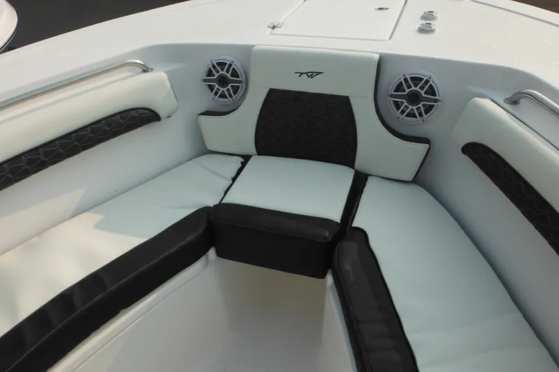 Slide: The Image of 2026 Tidewater 232 LXF boat interior with cushioned seating and built-in speakers. - 68