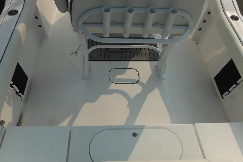 Slide: The Image of 2026 Tidewater 232 LXF boat interior with rod holders and seating area. - 79