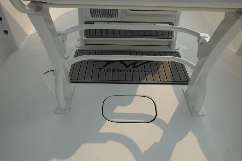 Slide: The Image of 2026 Tidewater 232 LXF boat interior with branded flooring and seating. - 83