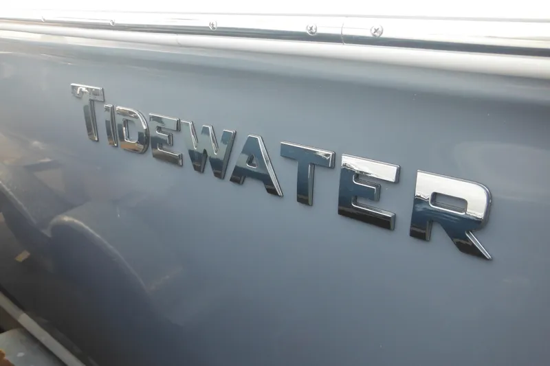 Slide: The Image of 2026 Tidewater 232 LXF boat logo on sleek gray surface. - 85