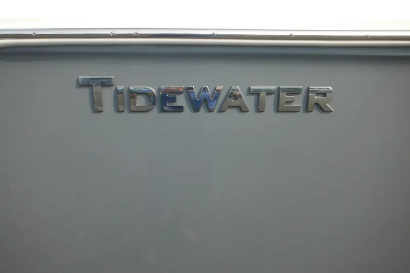 Slide: The Image of 2026 Tidewater 232 LXF boat logo on a sleek gray surface. - 86
