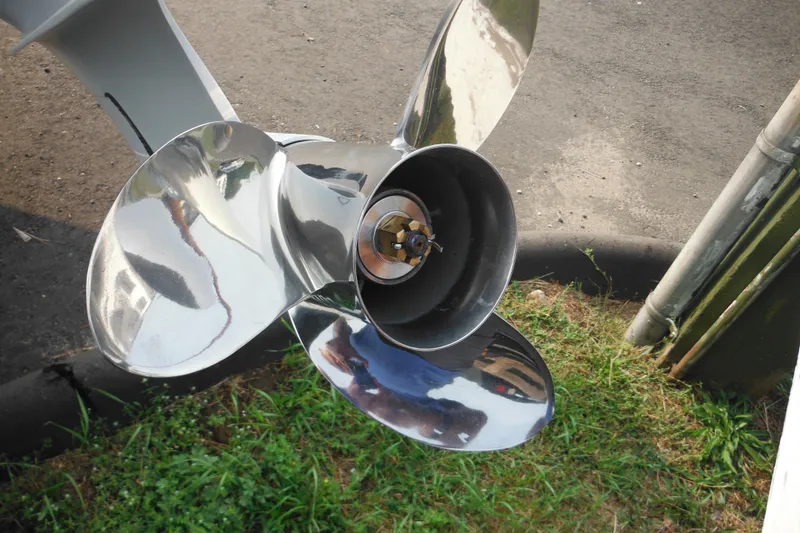 Slide: The Image of Shiny boat propeller of a 2026 Tidewater 232 LXF on grass and pavement. - 9