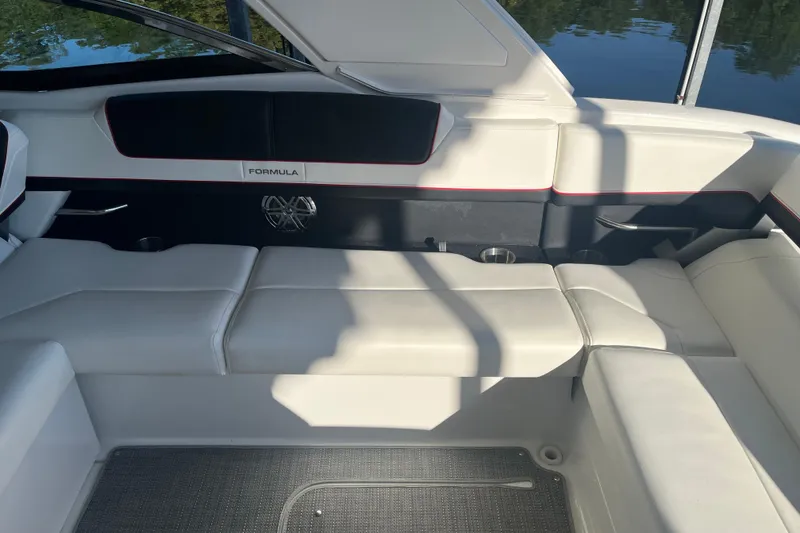 Slide: The Image of 2021 Formula 310 Bowrider I/O interior with white seating and sleek design. - 12