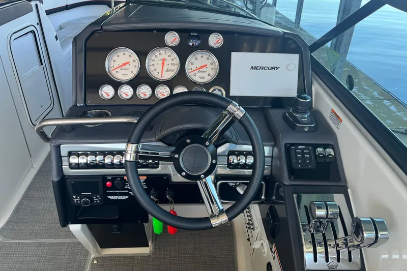 Slide: The Image of Dashboard of 2021 Formula 310 Bowrider I/O with steering wheel and Mercury controls. - 13