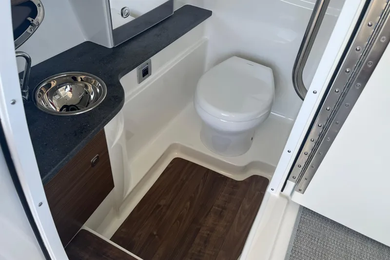 Slide: The Image of 2021 Formula 310 Bowrider I/O boat bathroom with sink and toilet. - 14