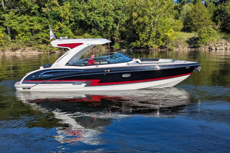 Slide: The Image of 2021 Formula 310 Bowrider I/O boat cruising on a serene lake. - 20