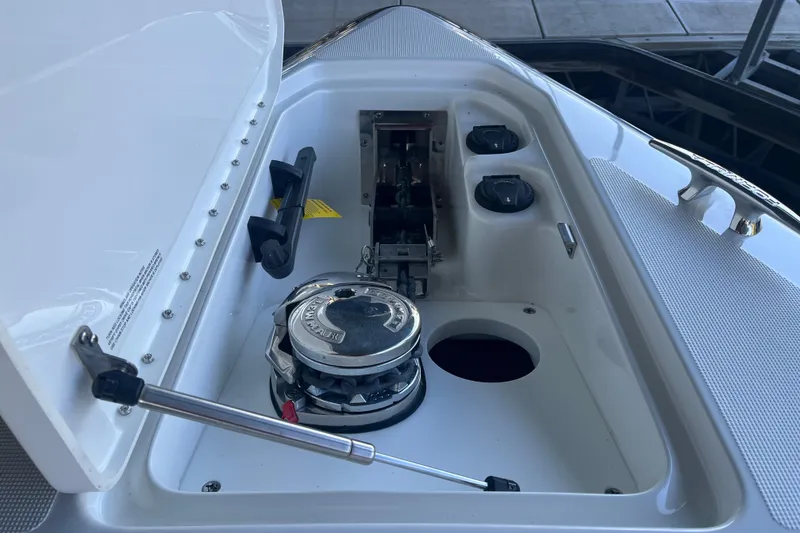 Slide: The Image of 2021 Formula 310 Bowrider I/O anchor compartment with windlass and controls. - 6