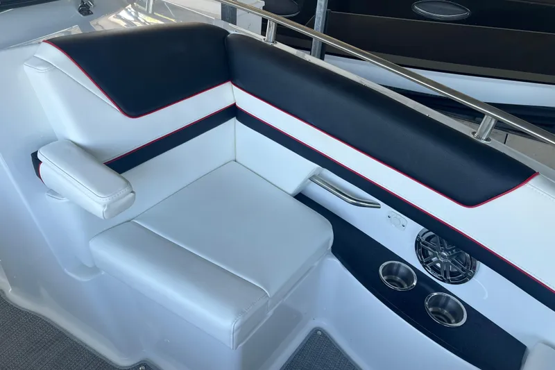 Slide: The Image of 2021 Formula 310 Bowrider I/O interior seating with cup holders and speaker. - 7