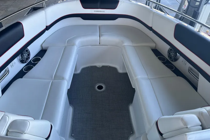 Slide: The Image of 2021 Formula 310 Bowrider I/O interior with white seating and cup holders. - 8