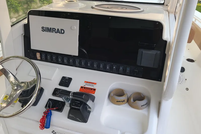 Slide: The Image of 2018 Sea Hunt Gamefish 25 dashboard with Simrad display and Yamaha controls. - 13