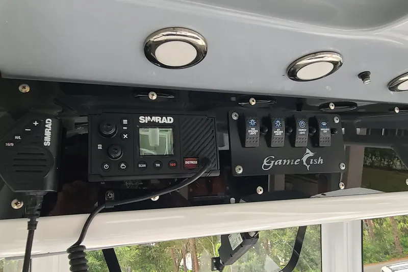 Slide: The Image of 2018 Sea Hunt Gamefish 25 dashboard with Simrad electronics and control switches. - 17