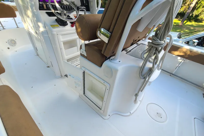 Slide: The Image of 2018 Sea Hunt Gamefish 25 boat interior with seating and storage compartments. - 22