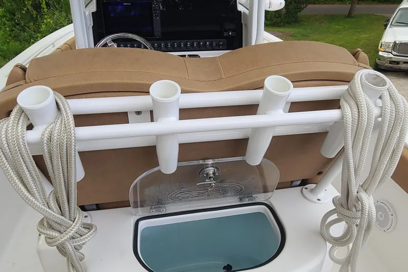 Slide: The Image of 2018 Sea Hunt Gamefish 25 boat interior with rod holders and ropes. - 25