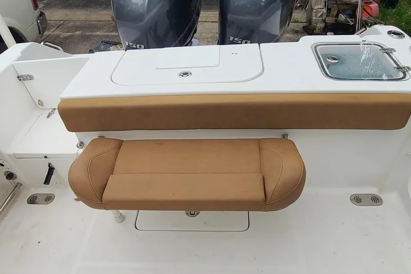 Slide: The Image of 2018 Sea Hunt Gamefish 25 boat interior with tan seating and livewell. - 29
