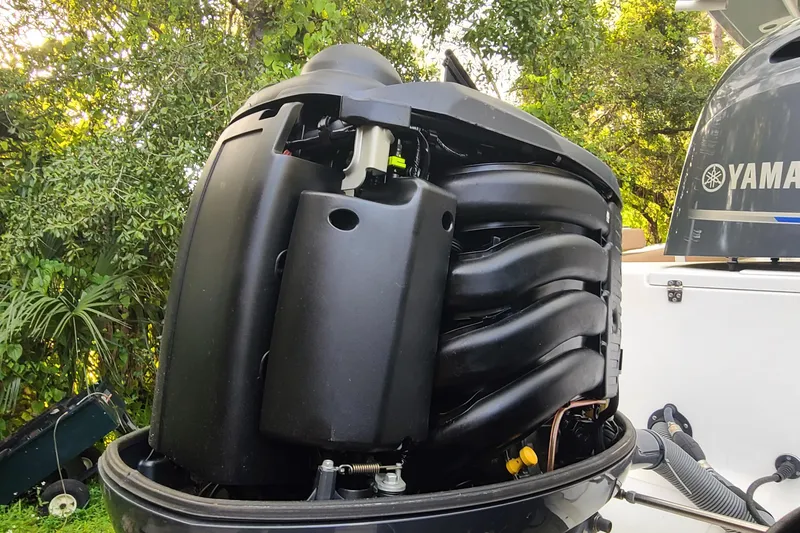 Slide: The Image of 2018 Sea Hunt Gamefish 25 with Yamaha outboard engine, surrounded by lush greenery. - 39