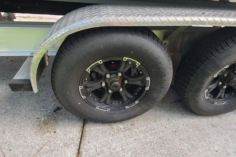 Slide: The Image of Trailer wheels of a 2018 Sea Hunt Gamefish 25 boat on concrete surface. - 46