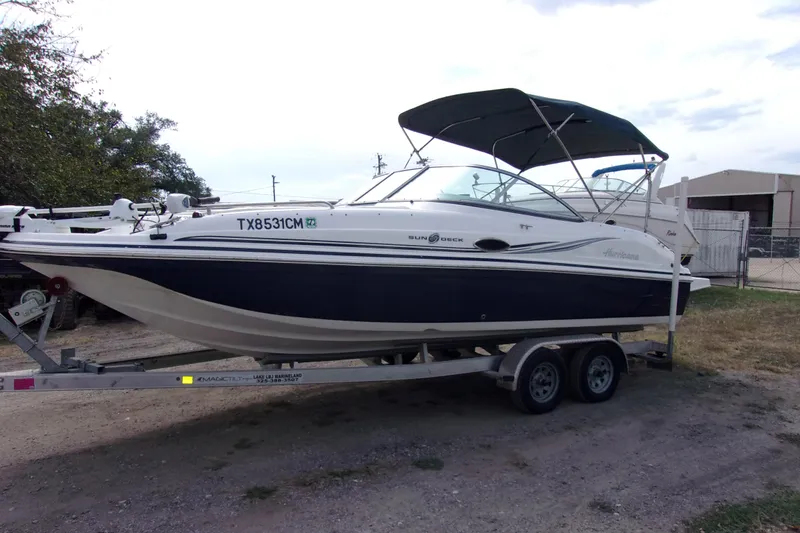 The Image of 2014 Hurricane Sundeck 217 IO boat on trailer, parked outdoors. - 1