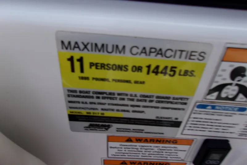 Slide: The Image of 2014 Hurricane Sundeck 217 IO capacity label: 11 persons or 1445 lbs. - 13