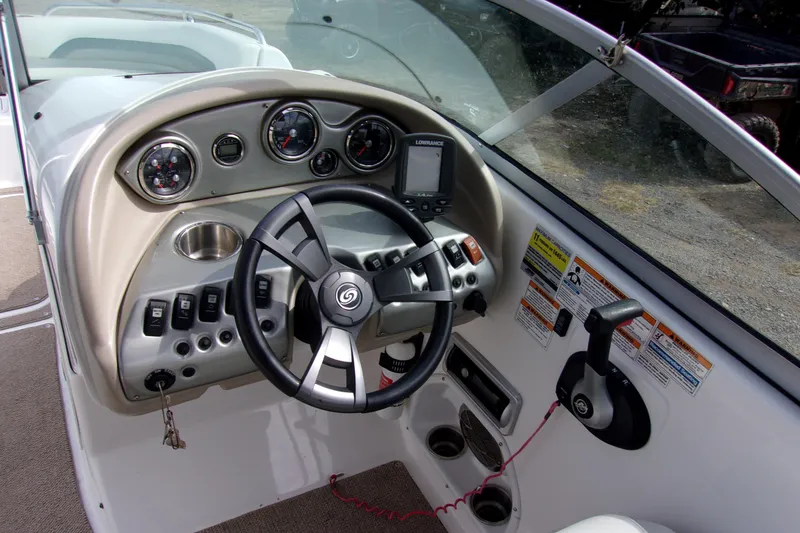 Slide: The Image of 2014 Hurricane Sundeck 217 IO boat dashboard with steering wheel and control panel. - 4