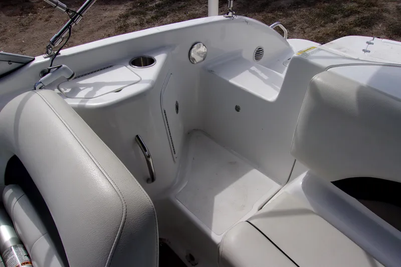 Slide: The Image of 2014 Hurricane Sundeck 217 IO boat interior with white seating and cup holder. - 8