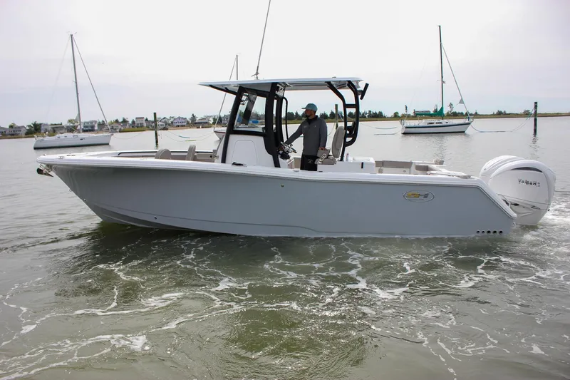 Slide: The Image of 2026 Sea Hunt Gamefish 28 Forward Seating boat with dual Yamaha engines in calm waters. - 1