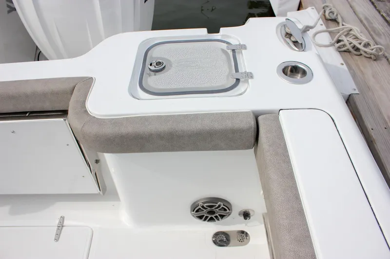 Slide: The Image of 2026 Sea Hunt Gamefish 28 Forward Seating boat interior with cushioned seating and storage compartment. - 11