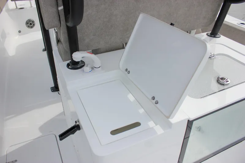Slide: The Image of 2026 Sea Hunt Gamefish 28 Forward Seating boat interior with open storage compartment. - 16