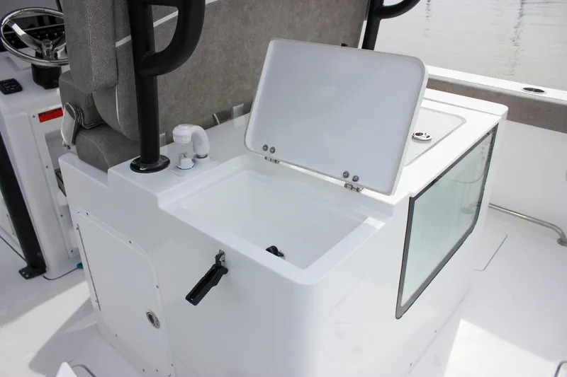 Slide: The Image of 2026 Sea Hunt Gamefish 28 Forward Seating boat interior with open storage compartment. - 17