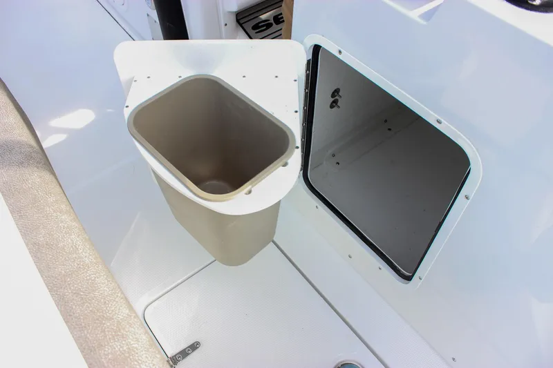 Slide: The Image of 2026 Sea Hunt Gamefish 28 Forward Seating boat interior with storage compartment and trash bin. - 19