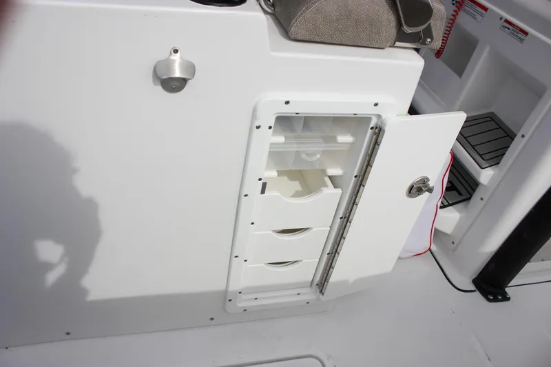 Slide: The Image of 2026 Sea Hunt Gamefish 28 storage compartment with open door and organized interior drawers. - 24