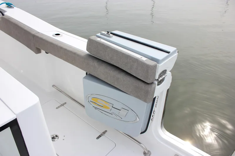 Slide: The Image of 2026 Sea Hunt Gamefish 28 boat with cushioned seating and storage compartment. - 27