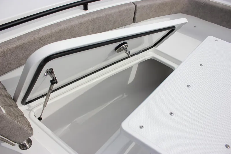 Slide: The Image of 2026 Sea Hunt Gamefish 28 Forward Seating storage compartment open, showcasing interior space. - 32