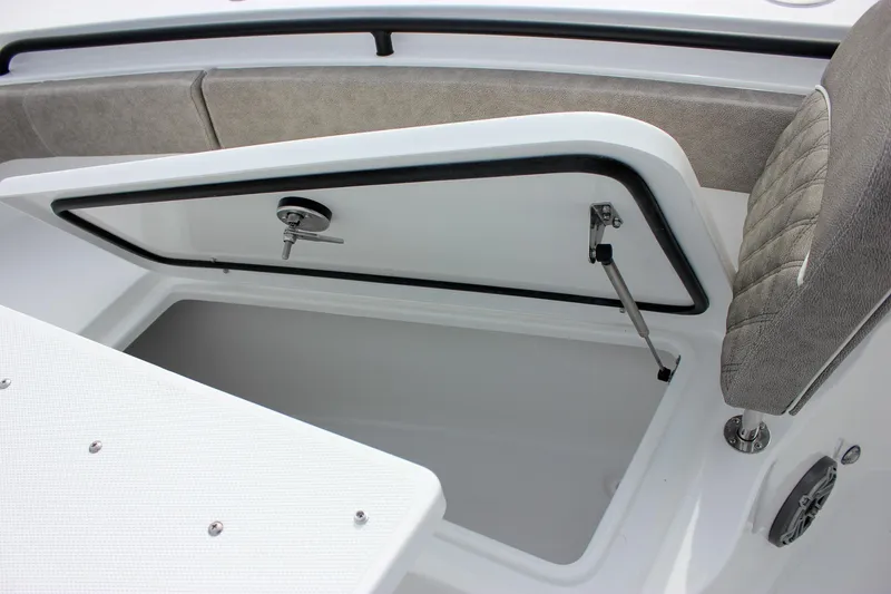 Slide: The Image of 2026 Sea Hunt Gamefish 28 Forward Seating storage compartment with open hatch and cushioned seating. - 33