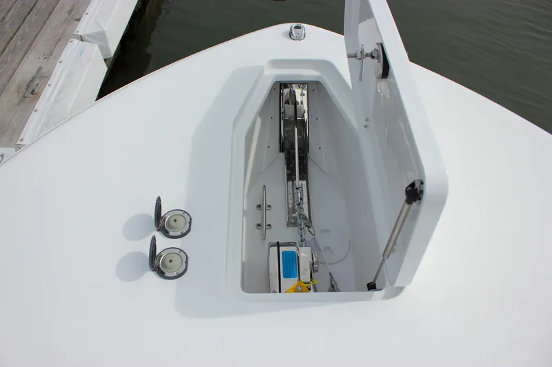 Slide: The Image of 2026 Sea Hunt Gamefish 28 anchor locker with open hatch, showcasing chain and winch. - 36