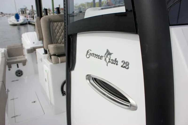 Slide: The Image of 2026 Sea Hunt Gamefish 28 Forward Seating boat interior with logo detail. - 4