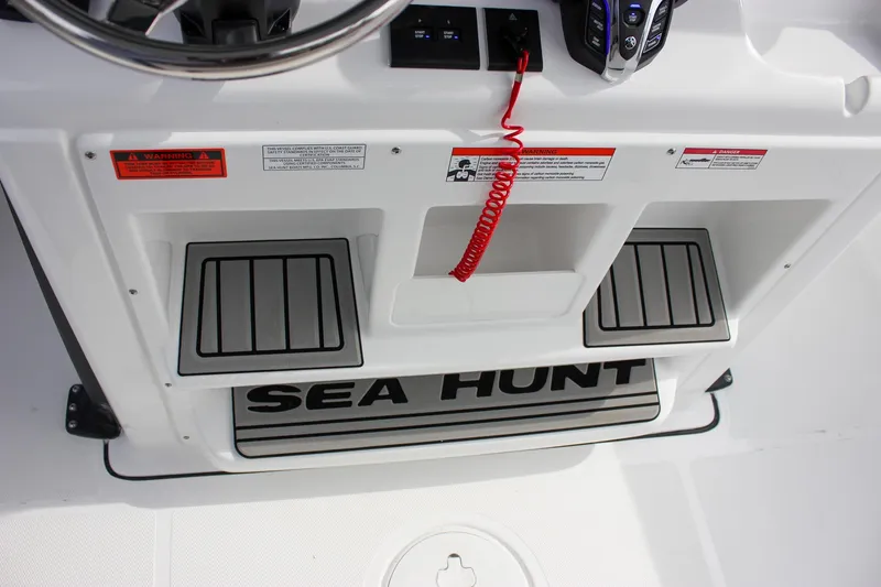 Slide: The Image of 2026 Sea Hunt Gamefish 28 console with steering wheel and safety features. - 42