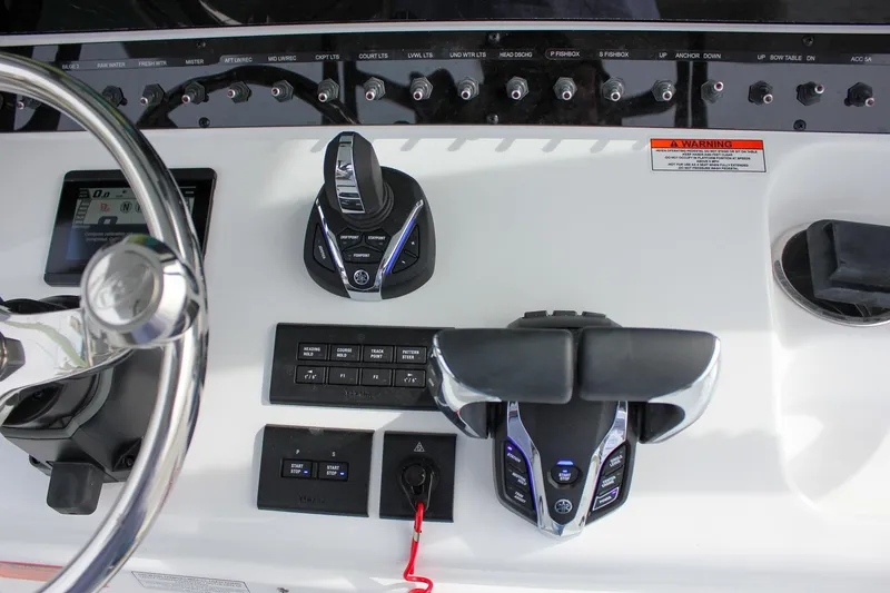 Slide: The Image of Control panel of 2026 Sea Hunt Gamefish 28 Forward Seating boat with steering wheel and switches. - 47