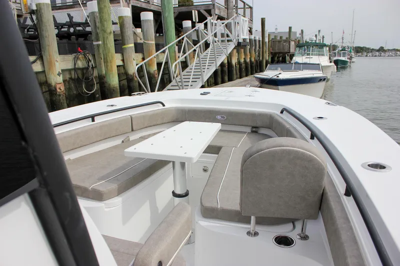 Slide: The Image of 2026 Sea Hunt Gamefish 28 Forward Seating boat docked, featuring spacious seating and table. - 49