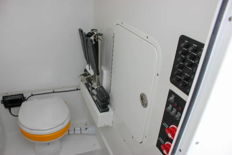 Slide: The Image of 2026 Sea Hunt Gamefish 28 Forward Seating boat interior with toilet and control panel. - 56