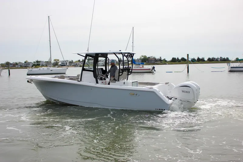 Slide: The Image of 2026 Sea Hunt Gamefish 28 Forward Seating boat cruising in calm waters. - 60
