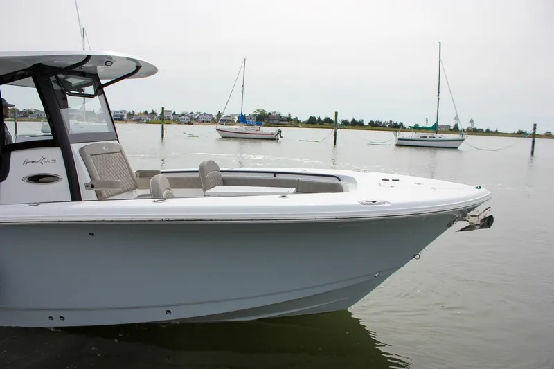 Slide: The Image of 2026 Sea Hunt Gamefish 28 Forward Seating boat docked in calm waters. - 63